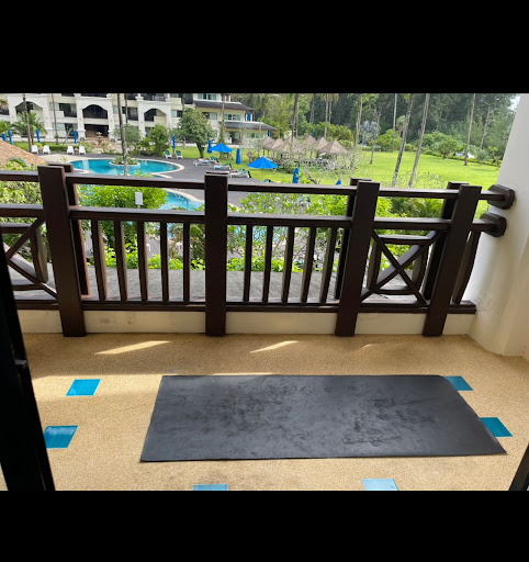 Yoga mat on a balcony overlooking the pool at a Thai Khaolak resort.